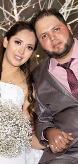 Elegant wedding couple seated together in festive decor.