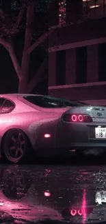 Sleek car with neon pink glow, reflecting on wet road at night.