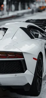 Sleek white sports car on urban street.