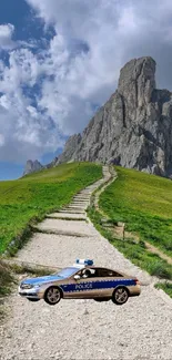 Mountain path with a parked police car under the blue sky.