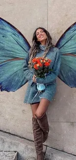 Person with butterfly wings holding red flowers against a beige wall.