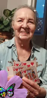 Joyful woman holding cards with a butterfly and floral design.