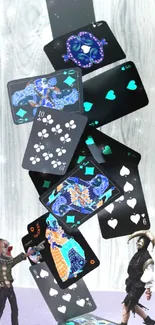 Whimsical playing cards tower with two figures on mobile wallpaper.