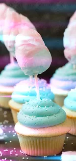 Cupcakes with blue frosting and cotton candy tops in a pastel theme.