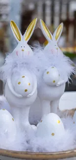 Easter bunnies with eggs and feathers in a festive display.