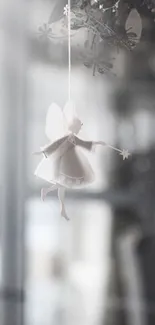 A delicate fairy figure hanging as a dreamy mobile wallpaper.