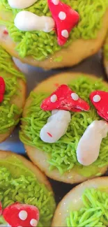 Whimsical cupcakes adorned with red mushrooms on vibrant green icing.