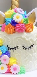 Unicorn-themed cake with colorful icing and flowers.