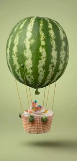 Whimsical watermelon balloon with cupcake basket on green backdrop.