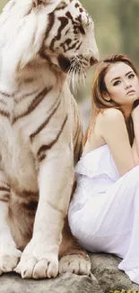 White tiger sitting with a woman in a serene setting.