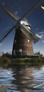 Windmill at night reflected in a moonlit lake with a crescent moon overhead.