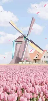 Windmill and pink tulips under a blue sky.