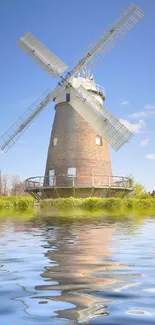 Windmill with water reflections under a blue sky mobile wallpaper.