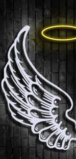 Neon wing and halo on dark brick wall.