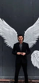 Man standing with white wings on a dark backdrop, creating a unique artistic visual.