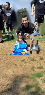 Celebration with trophy on a green field.