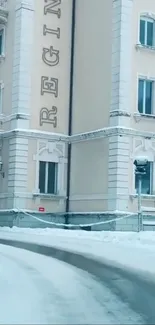 Snowy building on serene winter street.