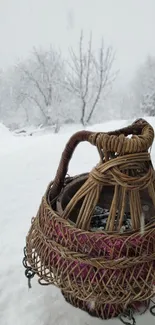 Wicker basket in snowy winter landscape.