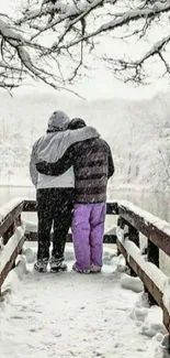 Couple embracing on snowy bridge in winter landscape.