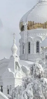 Snow-covered cathedral with golden domes in winter scenery.