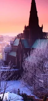 Gothic church silhouette at sunset with snowy landscape.