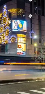 Festive city street scene with lights and snowflakes at night.