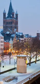 Snow-covered cityscape with historic architecture in the evening light.