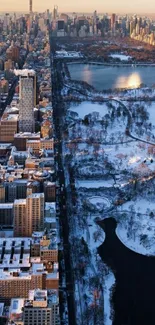 Aerial cityscape with snow and park under winter sunlight.