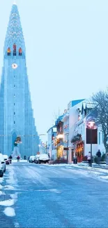 Serene winter cityscape featuring a snowy street and a towering church.