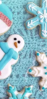 Winter-themed cookie wallpaper with snowflakes and snowmen on a blue background.