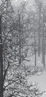 Grey toned winter forest wallpaper with falling snow.