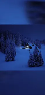 Snowy night forest with lighted cabin under a dark blue sky.