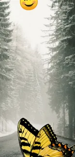 Snowy forest with butterfly and emoji on phone wallpaper.