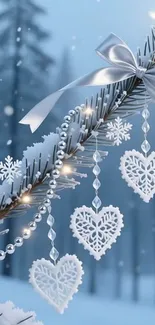 Winter scene with heart ornaments on snowy branch.