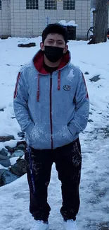 Person standing on snowy path in winter landscape.