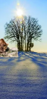 Bear beside a tree in a sunny winter landscape.