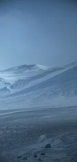 Blue winter mountain landscape with snowy peaks.