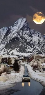 Serene winter night with a full moon over snowy mountains and village.