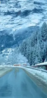 Snowy mountain road with serene winter landscape.