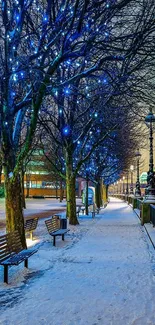 Winter cityscape with snow and blue lights on a riverside path at night.