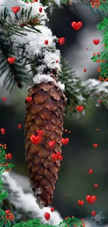 Snowy pine cone with red hearts on an evergreen branch wallpaper.