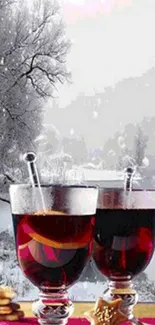 Two steaming red wine glasses in snowy landscape.