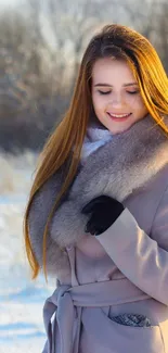 Woman in winter coat on snowy field with serene background.