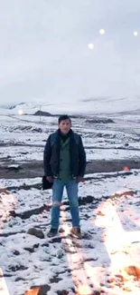 Man standing in snow-covered landscape.