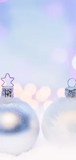 Snow-covered ornaments with blue bokeh background.