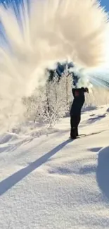 Man creates snow arc in winter landscape under blue sky.