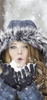 Woman in fur-lined hood blowing snowflakes in the winter.