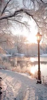 Snowy winter sunrise by a tranquil lake with a glowing streetlamp.