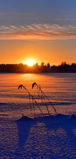 Sunset over a snowy field with vibrant orange and blue hues.