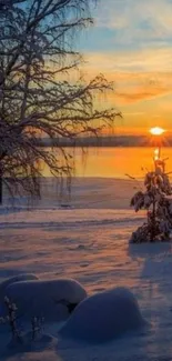 A serene winter sunset over a snowy landscape with a frozen lake.